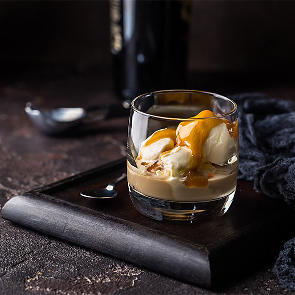 creamy shot of espresso over a scoop of icecream serced in a glass