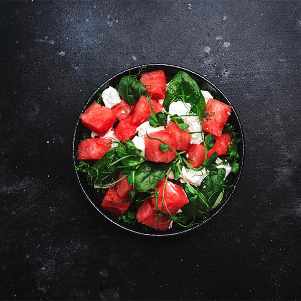 watermelon with creamy vegan cheese and greens